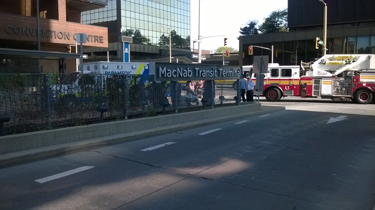 Photo of paramedics and firefighters tending to a woman struck by a HSR bus on July 21, 2016 at the MacNab Transit Terminal