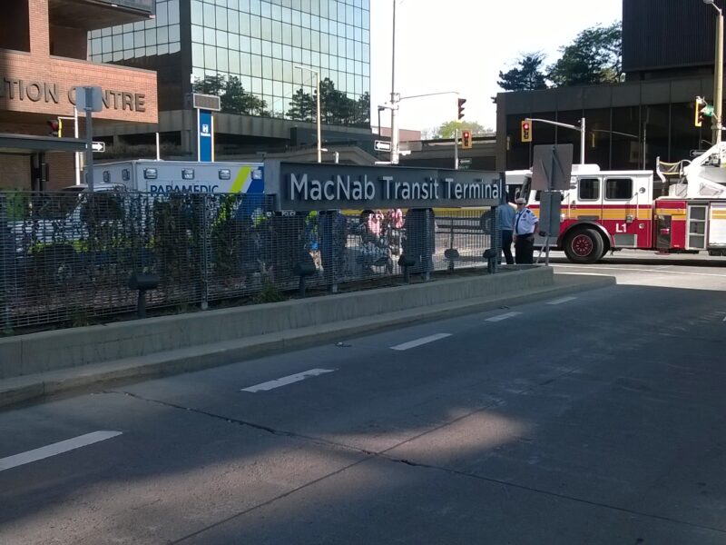 Photo of paramedics and firefighters tending to a woman struck by a HSR bus on July 21, 2016 at the MacNab Transit Terminal