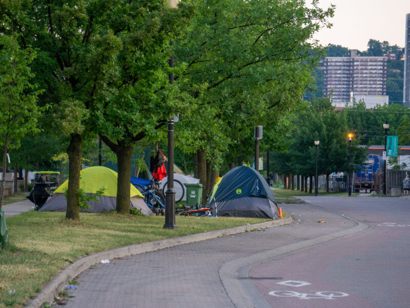 photos shows a group of tents alongside a roadway