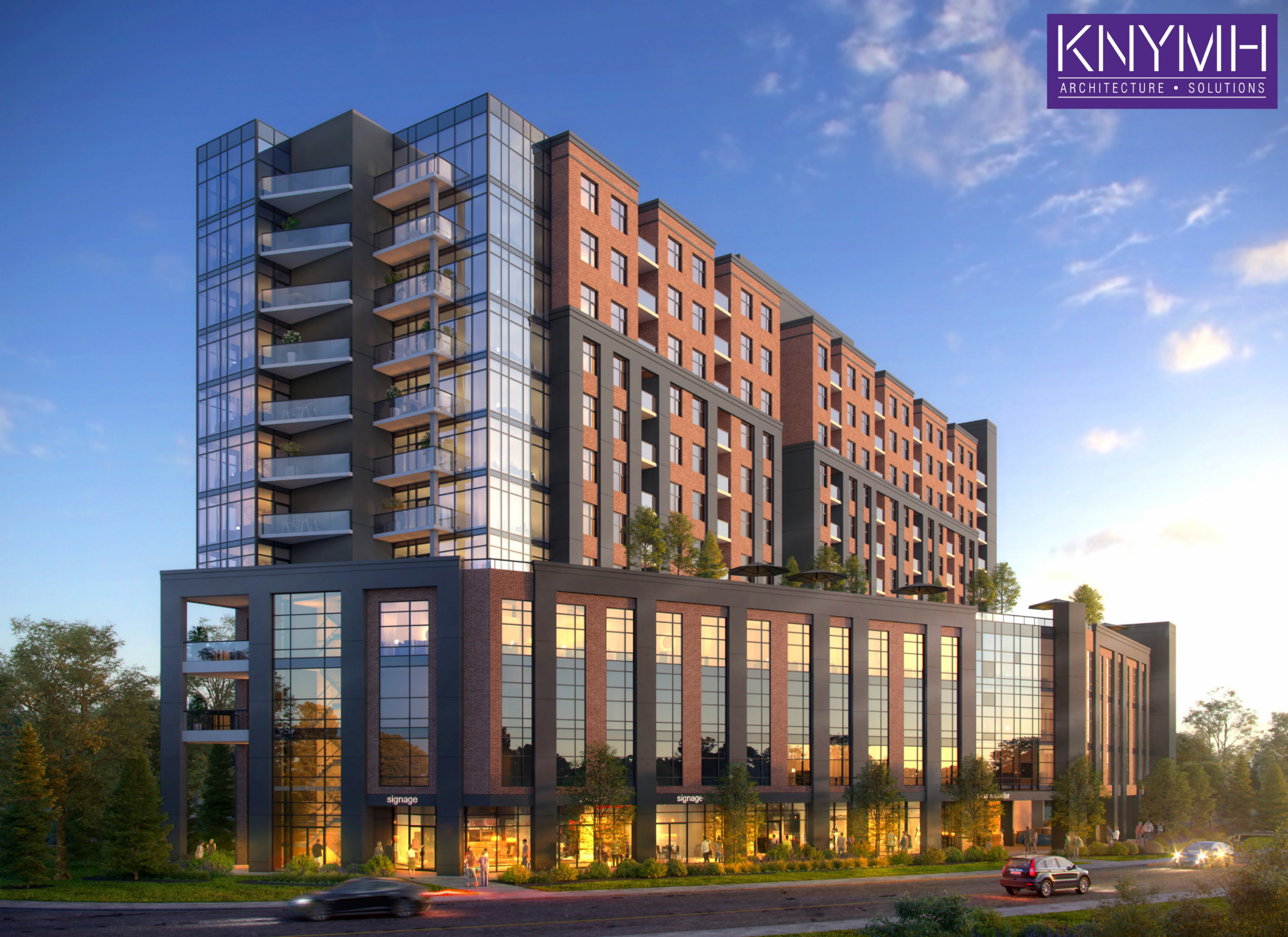 A digital architectural rendering displays a contemporary high-rise residential complex viewed from the street level during early evening daylight. The structure features a dark grey and glass five-storey podium topped with landscaped rooftop terraces, above which rise residential tower sections clad in traditional red brick and modern reflective glass. Balconies with glass railings are visible on multiple elevations. At the ground level, warmly lit commercial or amenity spaces feature large glass curtain walls, with illustrated pedestrians and vehicles traversing the adjacent roadway. The corporate logo for KNYMH Architecture + Solutions appears in the top right corner against a blue sky with scattered clouds.