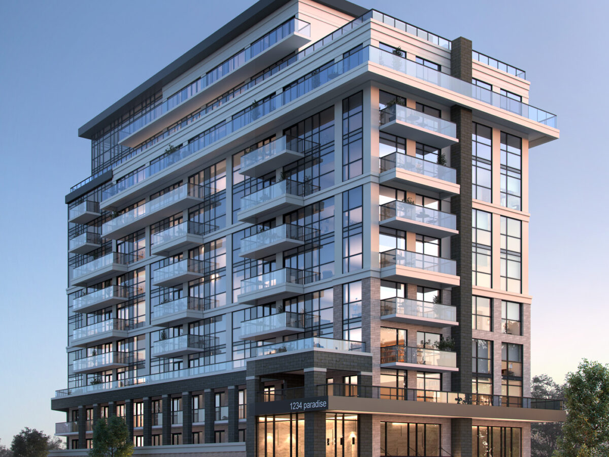 . A digital architectural rendering captures a contemporary multi-storey condominium building viewed from an eye-level corner perspective during the dusk hours. The structure is anchored by a two-storey podium featuring tall, warmly illuminated floor-to-ceiling glass windows and grey masonry framing, with a prominent entrance canopy bearing the signage 1234 paradise. Above the base, the residential tower rises with a structured facade composed of white precast framing, charcoal-grey vertical brick pilasters, extensive glass curtain wall sections, and protruding private balconies with transparent glass railings. The top floors feature terraced step-backs beneath a dark, cantilevered roof parapet. At ground level, manicured garden beds with pink flowering shrubs and low green hedges wrap around the perimeter, flanked by parked sedans and perimeter deciduous trees under a clear twilight sky fading from soft golden amber to pale blue.